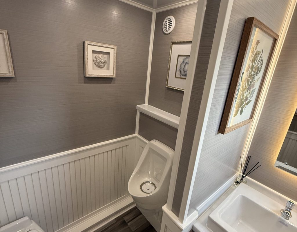 IMG_7292 Interior view of a luxury portable restroom showing vanity, lighting, and climate control