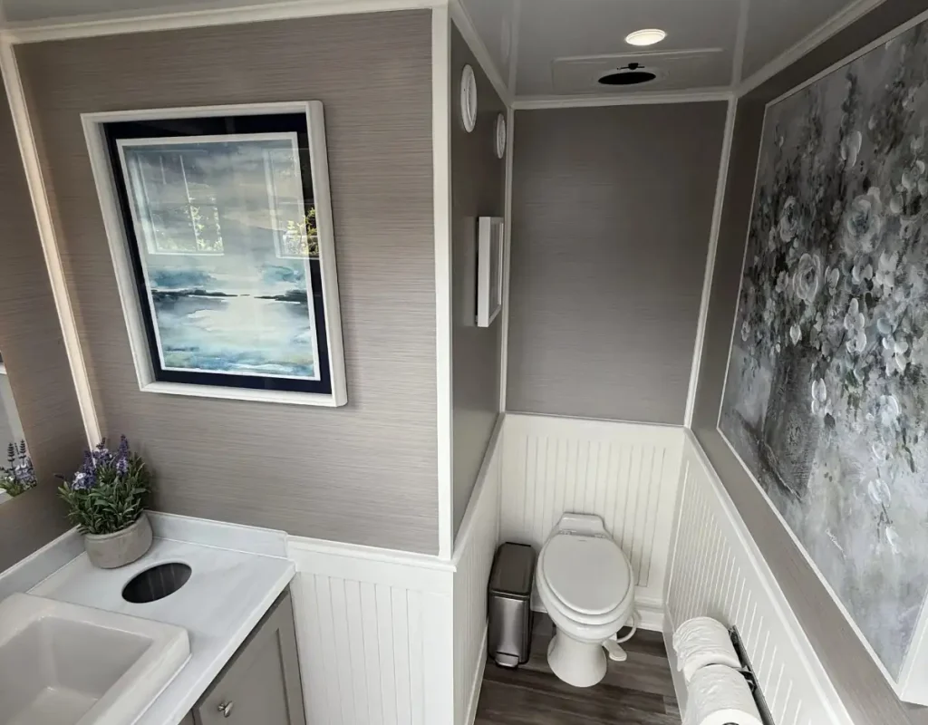 Luxury portable toilet interior with lighting, a mirror, and an occupancy indicator in North Park.