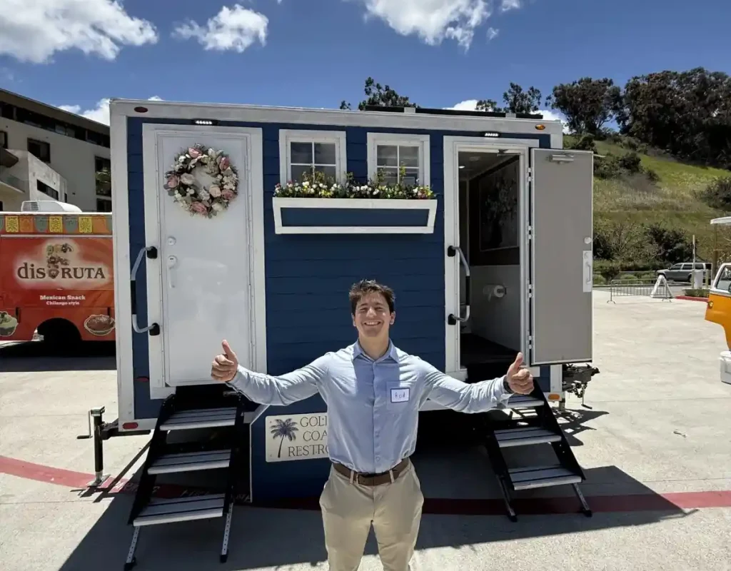 Luxury portable restroom placed beside a clear guest pathway at a Hillcrest event. luxury porta potty near me